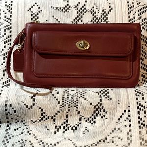 Coach Leather Wine Red Wristlet with Gold Turn Lock on exterior pocket